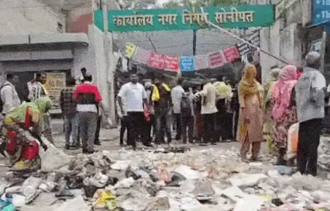 सोनीपत: निगम गेट पर कूड़ा डाल सफाईकर्मियों ने प्रदर्शन किया